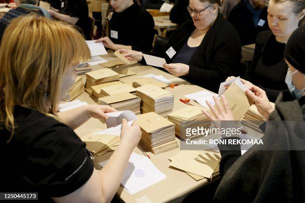 Officials start counting the advance votes of the Finnish parliamentary elections at the Kallio administrative building in Helsinki on April 2, 2023....