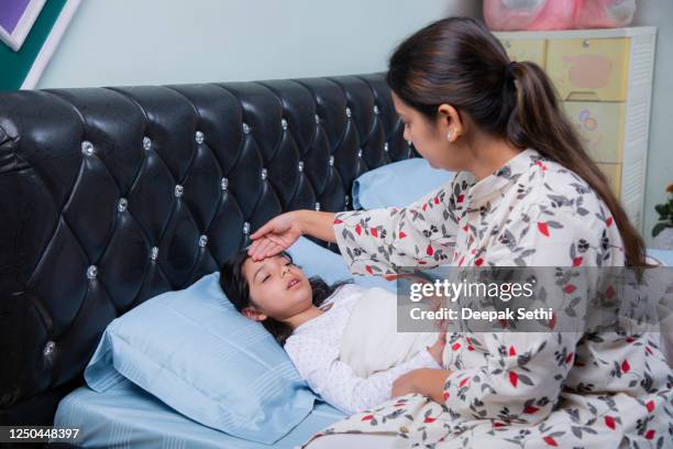 sick child with high fever stock photo - indian mother and child stock pictures, royalty-free photos & images