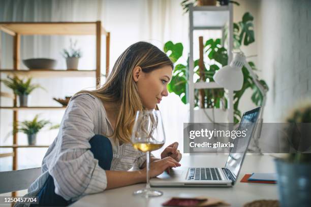 young woman working from home. - touchpad stock pictures, royalty-free photos & images