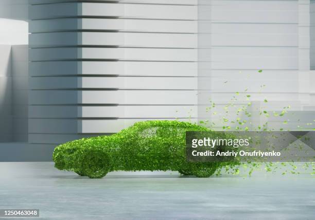 green car in city - ecosistema fotografías e imágenes de stock