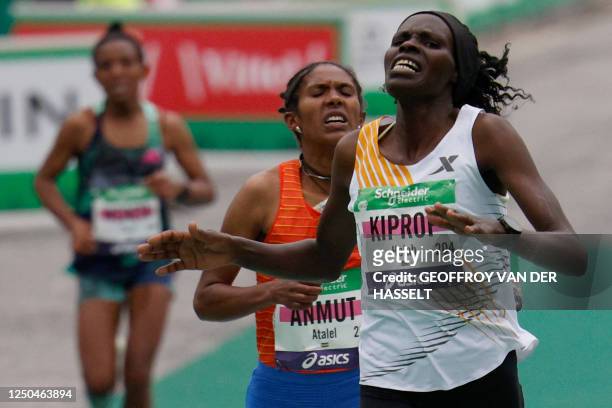 Kenya's Helah Kiprop crosses the finish line to win followed by second placed Ethiopian Atalel Anmut, in the women's 2023 Paris Marathon, at the Arc...