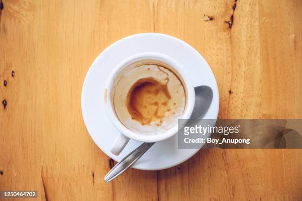 an empty glass cup of coffee on the wooden table. high angle view of a cup of coffee. - bar overhead foto e immagini stock