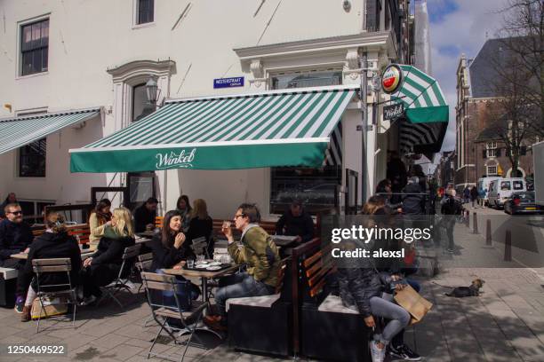 street cafe restaurant on noordermarkt market square in amsterdam - noordermarkt stock pictures, royalty-free photos & images