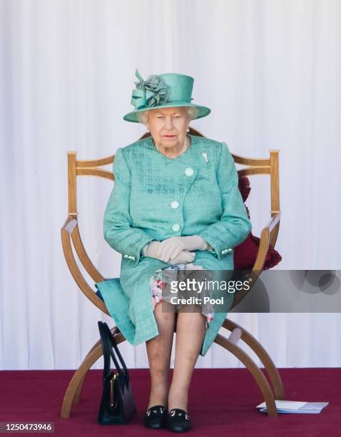 Queen Elizabeth II attends Trooping The Colour, the Queen's birthday ceremony at Windsor Castle on June 13, 2020 in Windsor, England. In line with...