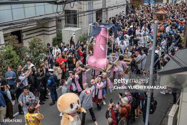 Graphic content / A phallic-shaped 'mikoshi' is paraded through the streets during the Kanamara festival in Kawasaki on April 2, 2023.