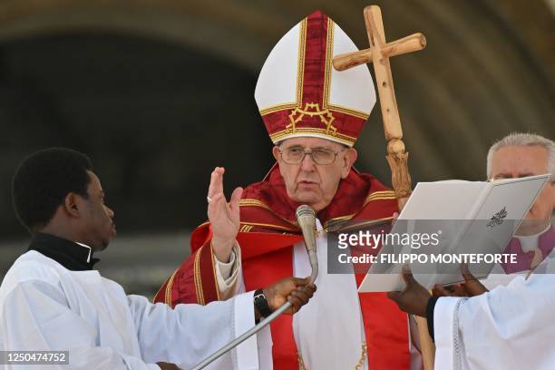 Pope Francis blesses the faithful as he delivers the Angelus prayer at the end of the Palm Sunday mass on April 2, 2023 at St. Peter's square in The...