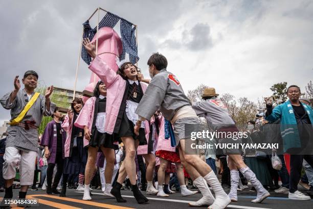 Graphic content / A phallic-shaped 'mikoshi' is paraded through the streets during the Kanamara festival in Kawasaki on April 2, 2023.