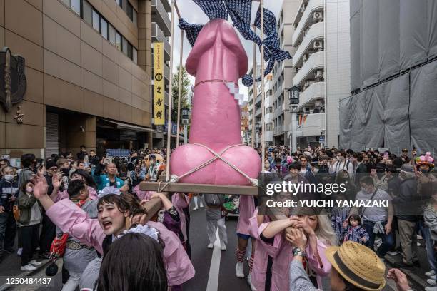 Graphic content / A phallic-shaped 'mikoshi' is paraded through the streets during the Kanamara festival in Kawasaki on April 2, 2023.