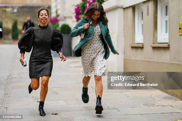 Guest wears a ruffled black dress with puff shoulders, earrings, black leather pointy shoes ; a guest wears a green blazer jacket, a white dress with...