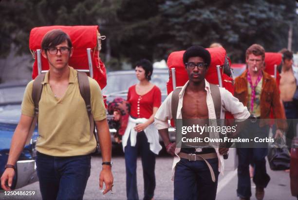 People with backpacks on their way to the Woodstock Music Festival, 1969.
