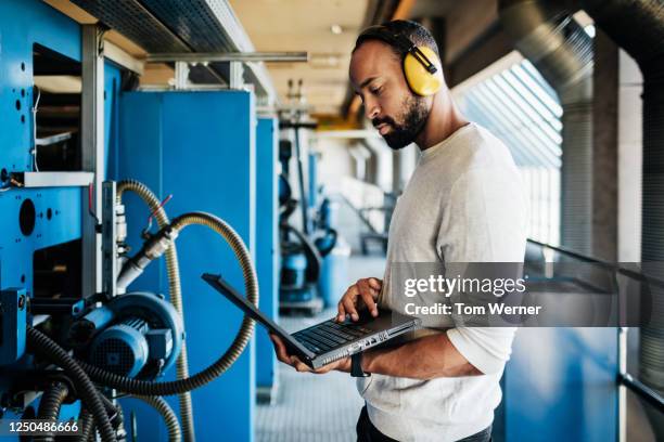 printery engineer concentrating while using laptop - big tom stock pictures, royalty-free photos & images