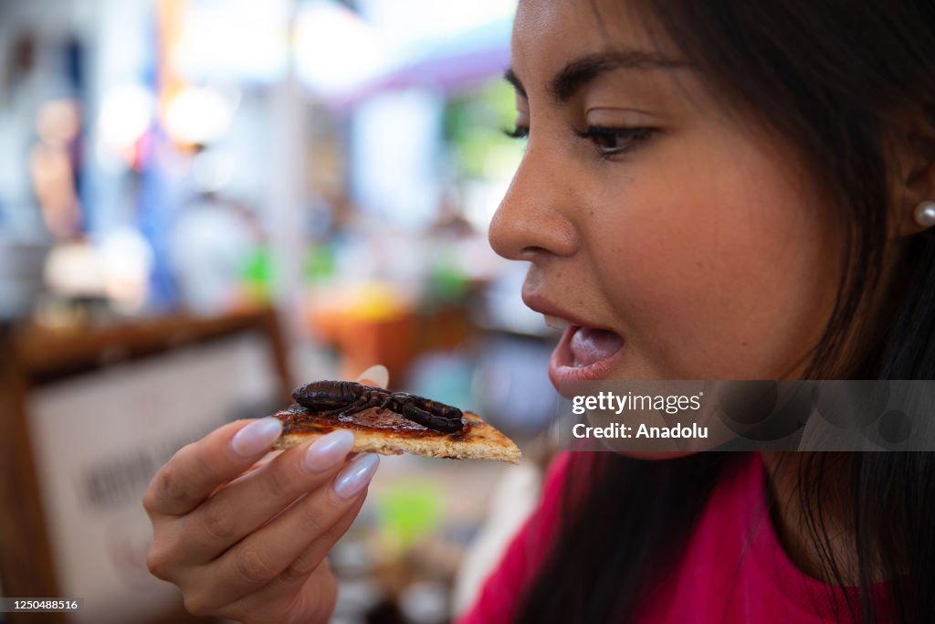 Insect Tasting A woman prepares to taste an arachnid during the Bichopolis insects ...
