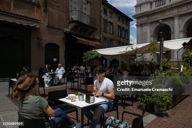 People have a drink at a bar in the Upper Town, on June 18, 2020 in Bergamo, Italy. The city of Bergamo is slowly returning to normality after the...