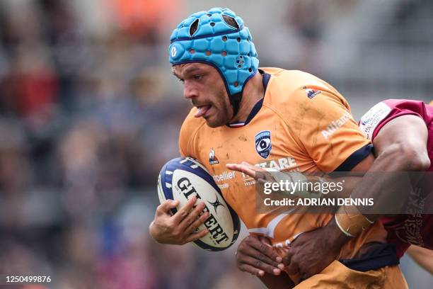 Montpellier's English number 8 Zach Mercer is tackled by Exeter Chiefs' Welsh flanker Christ Tshiunza during the European Rugby Champions Cup, Round...