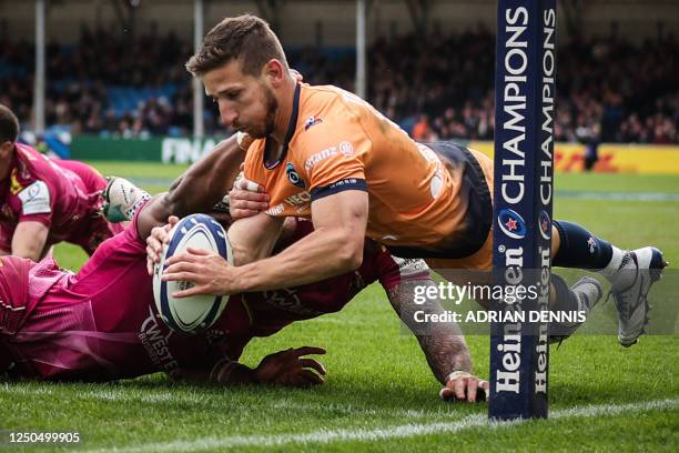Montpellier's French wing Vincent Rattez is tackled by Exeter Chiefs' English wing Jack Nowell and Exeter Chiefs' Welsh flanker Christ Tshiunza and...