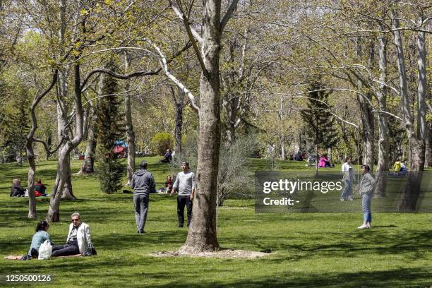 People gather at a park in the north of Tehran on April 2, 2023 as Iranians picnic outdoors with family and friends to mark "Sizdeh Bedar" , 13 days...