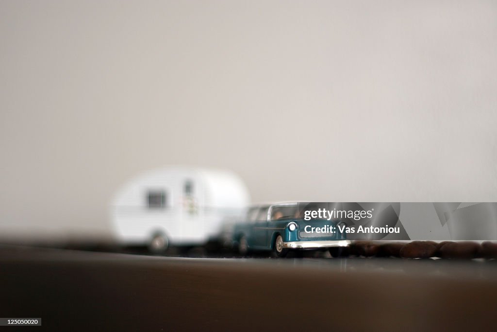 Tiny car pulling trailer