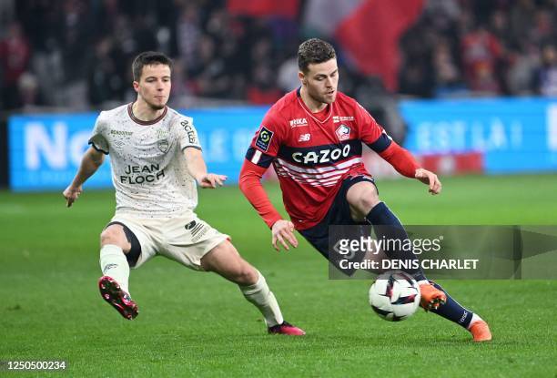 Lille's Swedish defender Gabriel Gudmundsson fights for the ball with Lorient's French midfielder Theo Le Bris during the French L1 football match...
