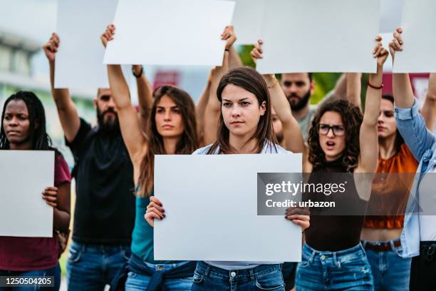 young people protesting at the street - political rally sign stock pictures, royalty-free photos & images