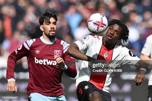 Southampton's Belgian midfielder Romeo Lavia vies with West Ham United's Brazilian midfielder Lucas Paqueta during the English Premier League...