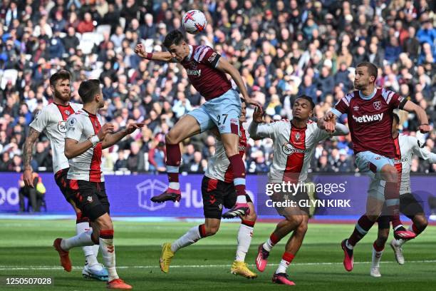 West Ham United's Moroccan defender Nayef Aguerd jumps to head home the opening goal of the English Premier League football match between West Ham...