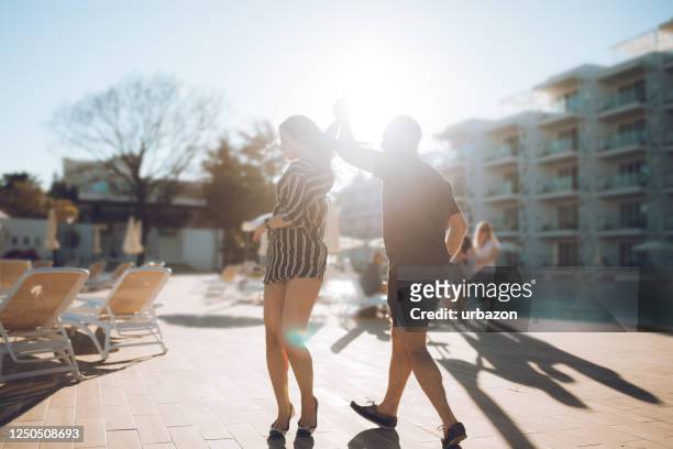 couple dancing by the hotel pool - cha cha stock pictures, royalty-free photos & images