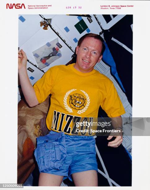 American NASA astronaut Richard N Richards wearing a t-shirt of his Alma Mater, the University of Missouri, in the middeck area of Space Shuttle...