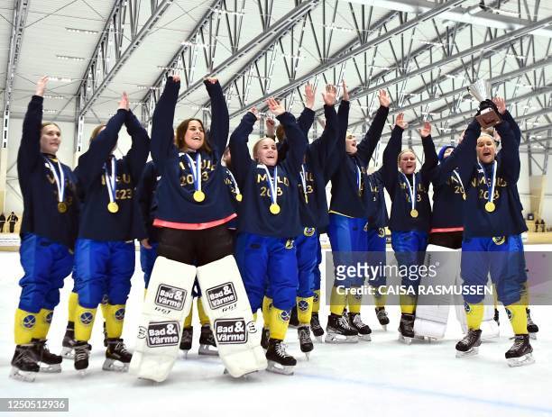 The Swedish women's team celebrates after winning gold after the Bandy World Championships final match between Sweden and Finland in the Eriksson...