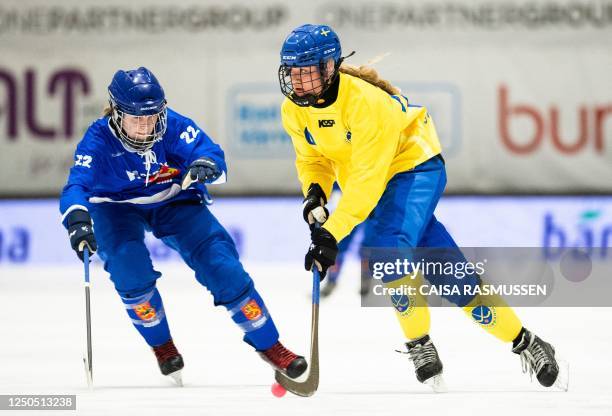 Finland's Kika Paljakka and Sweden's Tilda Ström vie during the Bandy World Championships final match between Sweden and Finland in the Eriksson...