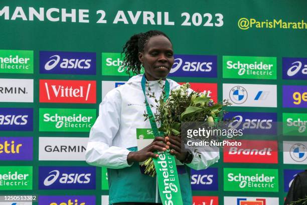 Kenya's Helah Kiprop pose on the podium with the second placed and third placed winners in the 2023 Paris Marathon,in Paris on April 2, 2023. The...