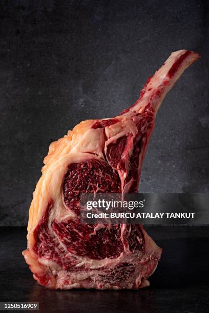 dry-aged angus bone-in rib steak - tomahawk stock pictures, royalty-free photos & images