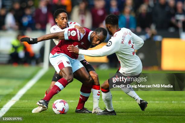 Michail Antonio of West Ham United holds off the challenge from Kyle Walker-Peters and Ainsley Maitland-Niles of Southampton during the Premier...