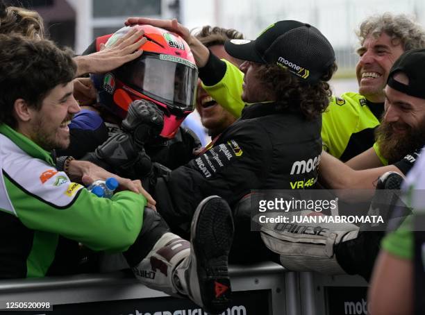 Italian rider Andrea Migno celebrates with teammates his third place in the Argentina Grand Prix Moto2 race, at Termas de Rio Hondo circuit, in...
