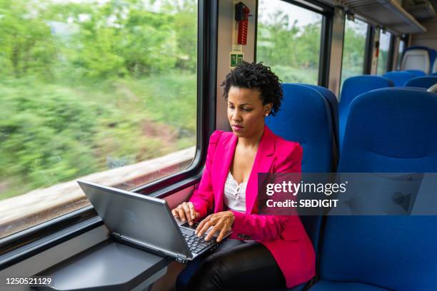 business woman traveling with train - purple suit woman stock pictures, royalty-free photos & images