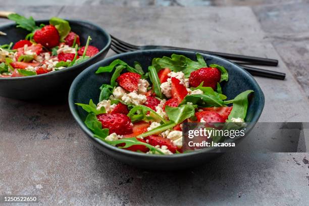 salad with arugula, strawberries and feta cheese and dressing - feta cheese stock pictures, royalty-free photos & images