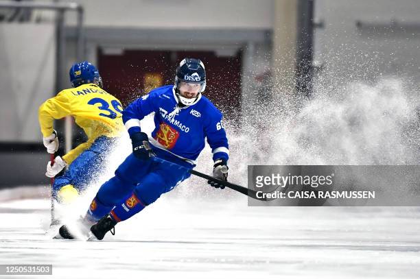 Sweden's Martin Landstrom and Finland's Topi Saukkonen vie during the bandy final between Sweden and Finland in the Men's Bandy World Cup in Eriksson...