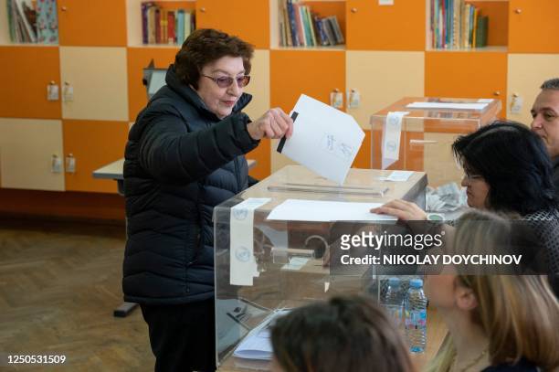Woman votes in Bulgarian parliamentary elections at a polling station in Sofia on April 2, 2023. - Bulgarians voted in their fifth general election...