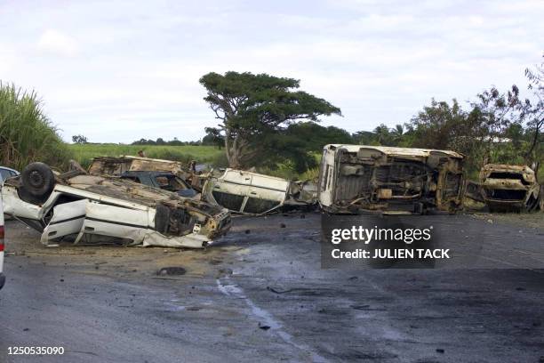 View taken on February 19, 2009 shows cars which were overturned to form a roadblock between La Boucan and Sainte-Rose on the French Caribbean island...