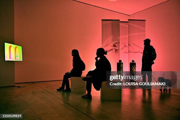 People visit the exhibition titled "Modern love" with their dogs during an event ahead of the World Stray Animals Day at the National Museum of...