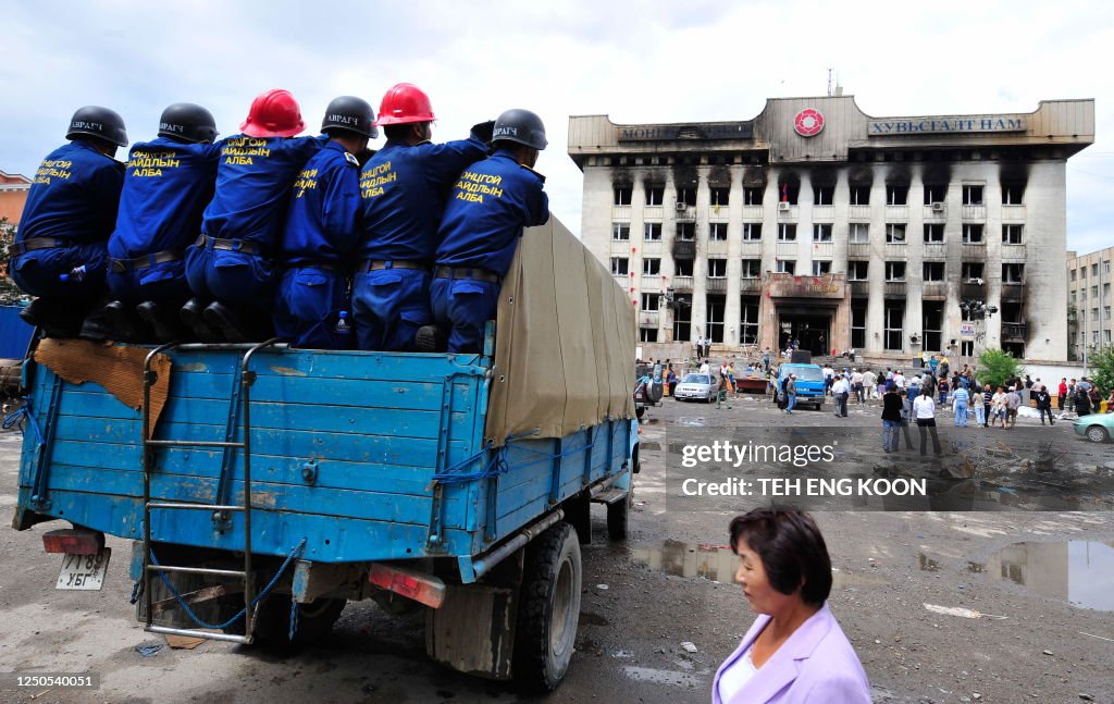 Mongolia Riots Mogolian special rescue team look at the destroyed headquarters of ...