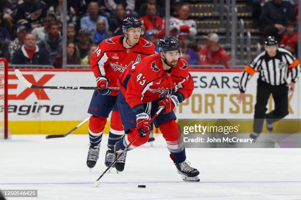 Washington Capitals right wing Tom Wilson skates the puck up the ice during a game against the New York Rangers at Capital One Arena on April 2, 2023...