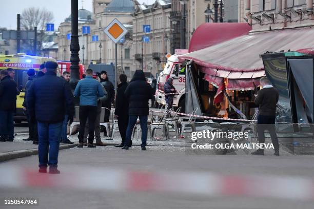 Russian police investigators inspect a damaged 'Street bar' cafe in a blast in Saint Petersburg on April 2, 2023. - A leading Russian military...