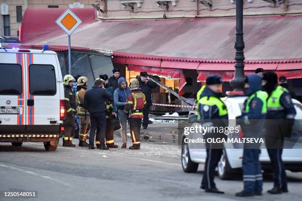 Russian police investigators inspect a damaged 'Street bar' cafe in a blast in Saint Petersburg on April 2, 2023. - A leading Russian military...