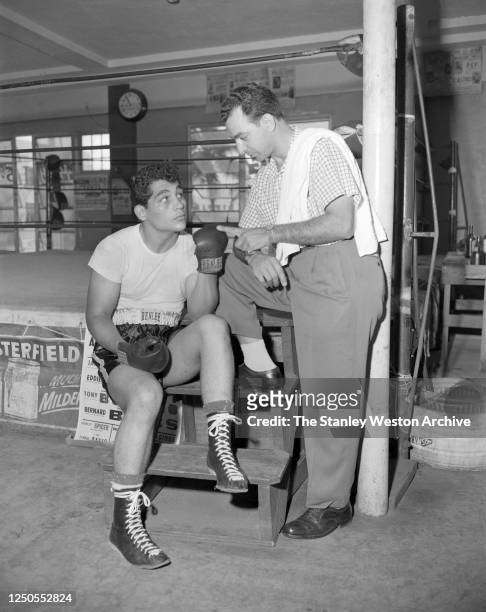 Light heavyweight professional boxer Willie Pastrano of the United States gets instructions from his trainer Angelo Dundee of the United States on...