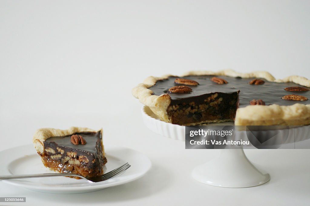 Chocolate pecan pie on cake stand