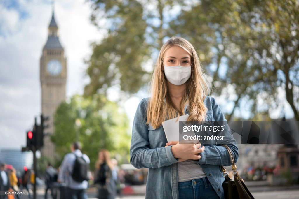 Woman outdoors wearing a facemask while walking around London