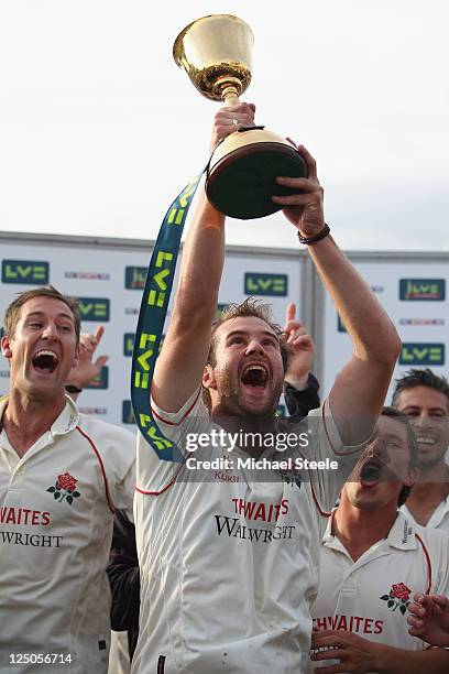 Tom Smith holds aloft the Championship trophy alongside Mark Chilton and Simon Kerrigan during the LV County Championship match between Somerset and...