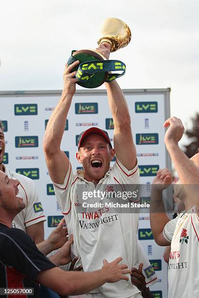 Gary Keedy of Lancashire lifts the Championship trophy after his sides eight wicket victory during the LV County Championship match between Somerset...