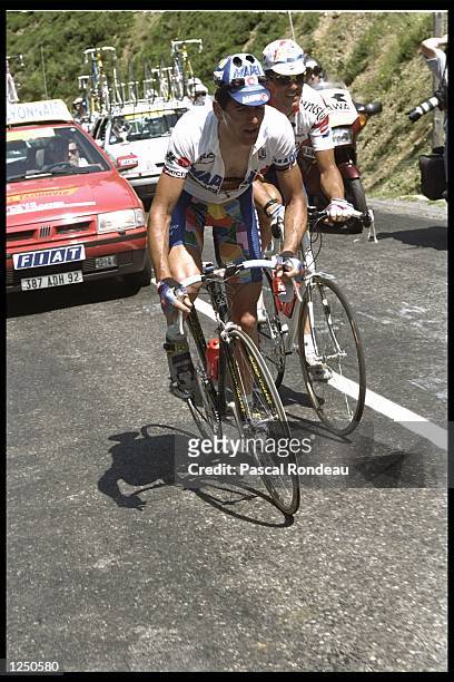 Abraham Olano of Spain and teammate Miguel Indurain of Spain struggle on the climb up to Pampelune during stage 17 of the Tour De France from Argeles...