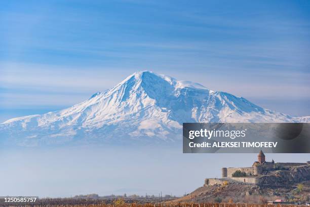 mount ararat is located on the turkish territory with a view of the ancient monastery of khor virap on a bright sunny day. with a hazy haze on the sky in the fall in the season yellow-golden brown. - armenian church stock pictures, royalty-free photos & images